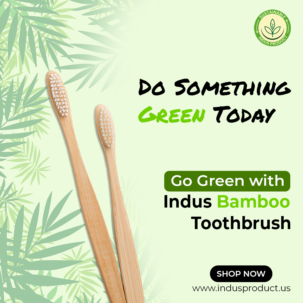 Two bamboo toothbrushes on a green leafy background with promotional text for Indus Bamboo Toothbrush.