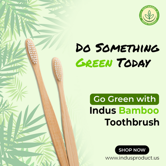 Two bamboo toothbrushes on a green leafy background with promotional text for Indus Bamboo Toothbrush.